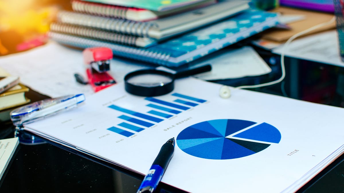 Ahrefs and AI: keyword research and SEO data analysis Ahrefs and AI – keyword analysis on paper with charts, magnifying glass, pen, and keyboard