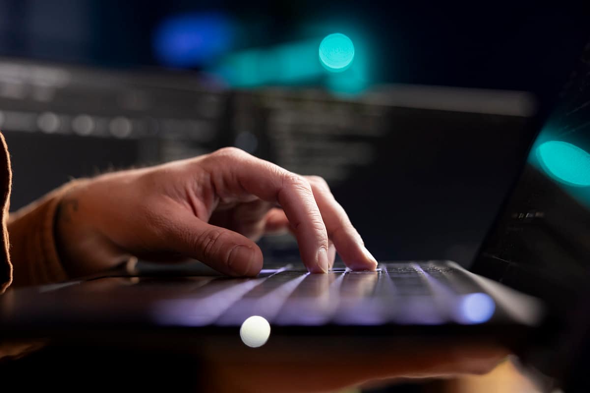 AI Prompts – Creating and Earning Hands typing a prompt on a laptop – working with AI