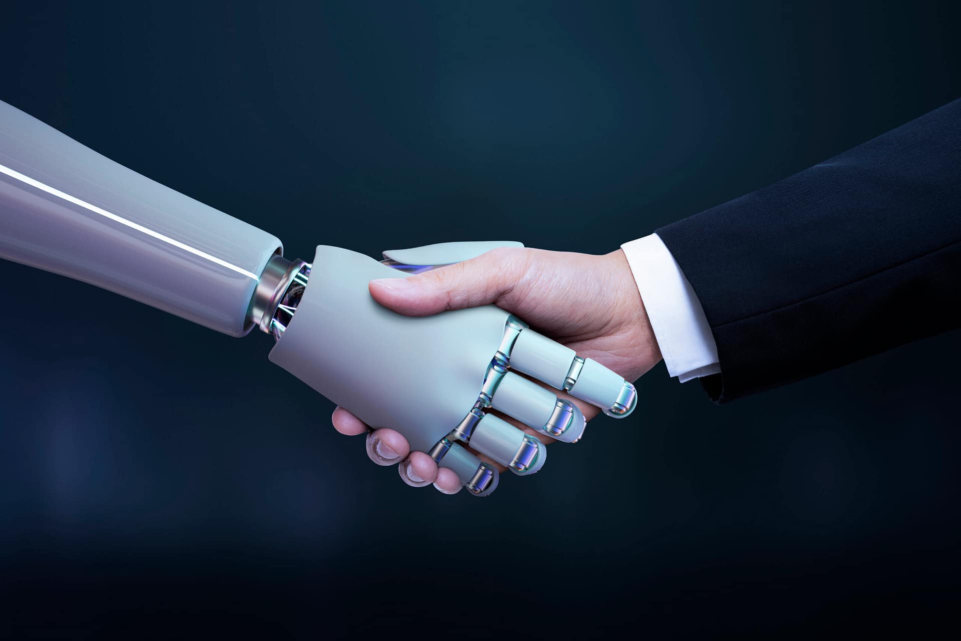 Człowiek w garniturze podający rękę robotowi – symbol współpracy człowieka z AI w biznesie